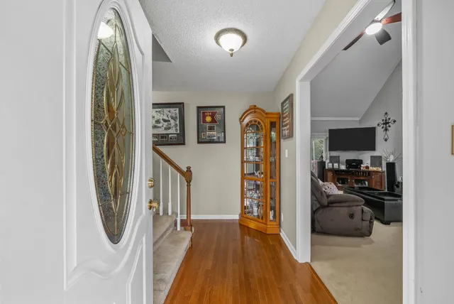 a living room with furniture a flat screen tv and a fireplace