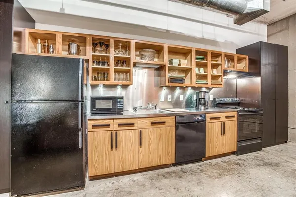 a kitchen with stainless steel appliances granite countertop a stove and a refrigerator