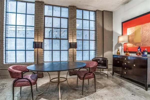 a living room with lots of furniture and kitchen view