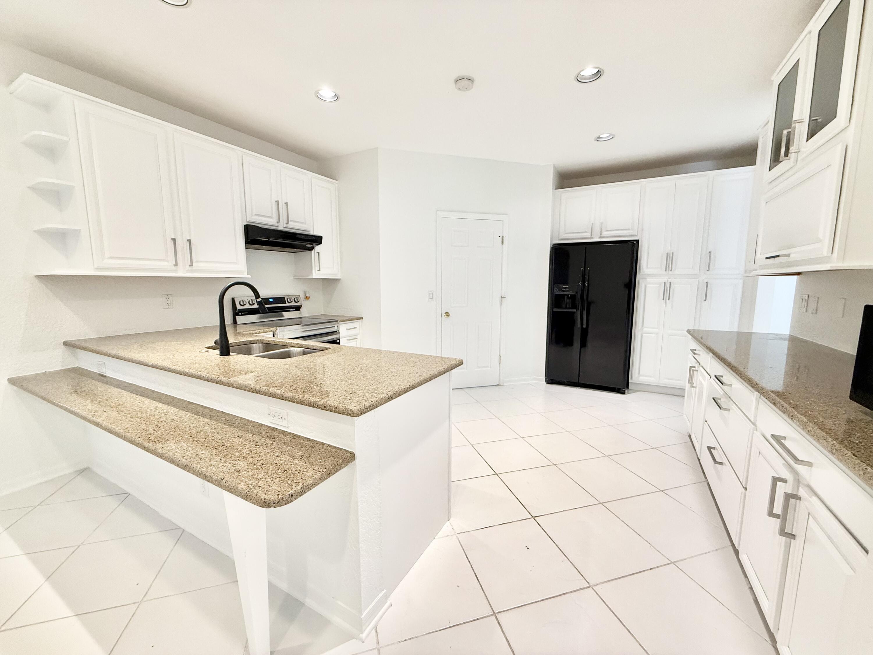 12310 Riverfalls Court Boca Raton, FL 33428 - Photo 3 of 30 GRANITE KITCHEN W/ WOOD CABINETS