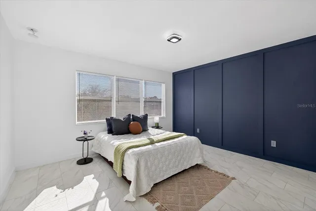 a bedroom with a bed and a window