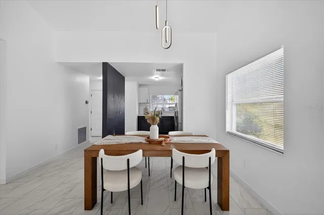 a dining room with furniture and window
