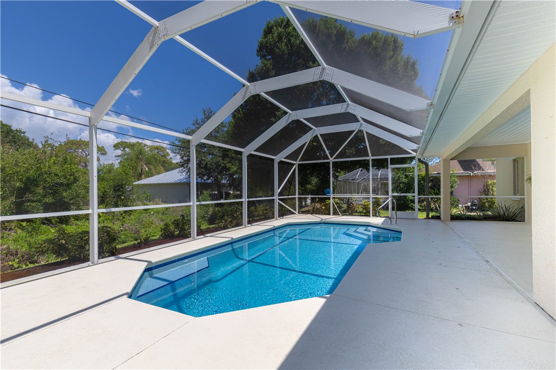 414 Ash Street Sebastian, FL 32958 - Photo 31 of 36 a view of a backyard with table and chairs and wooden fence