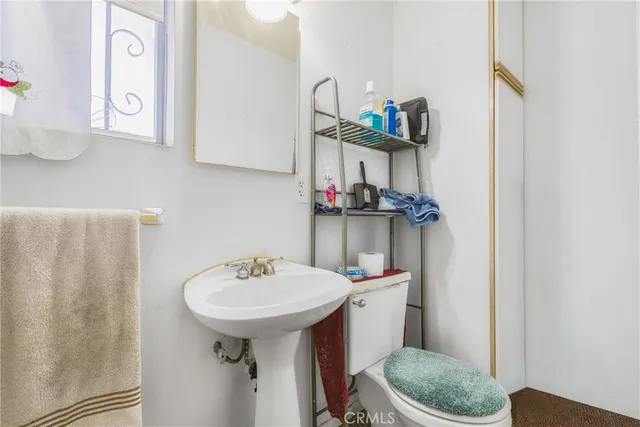 a bathroom with a sink toilet and a mirror