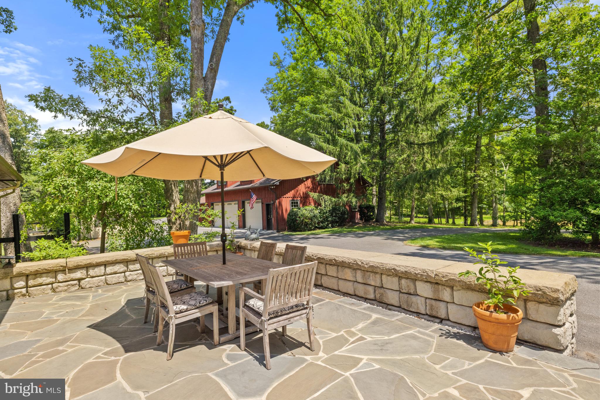 97 Tilthammer Mill Road Boyce, VA 22620 - Photo 31 of 68 a view of patio with chairs and table under an umbrella
