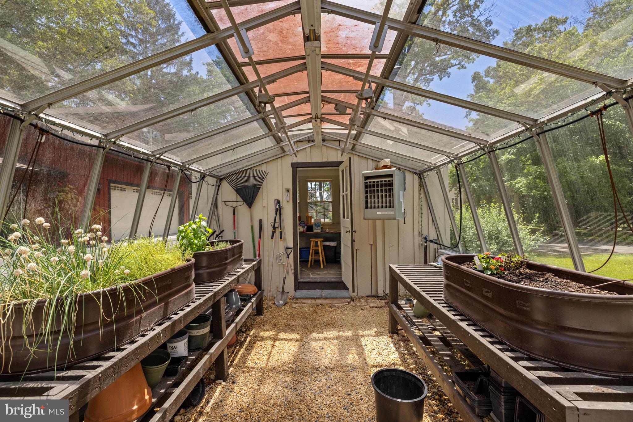 97 Tilthammer Mill Road Boyce, VA 22620 - Photo 33 of 68 a room with lots of potted plants and wooden floor
