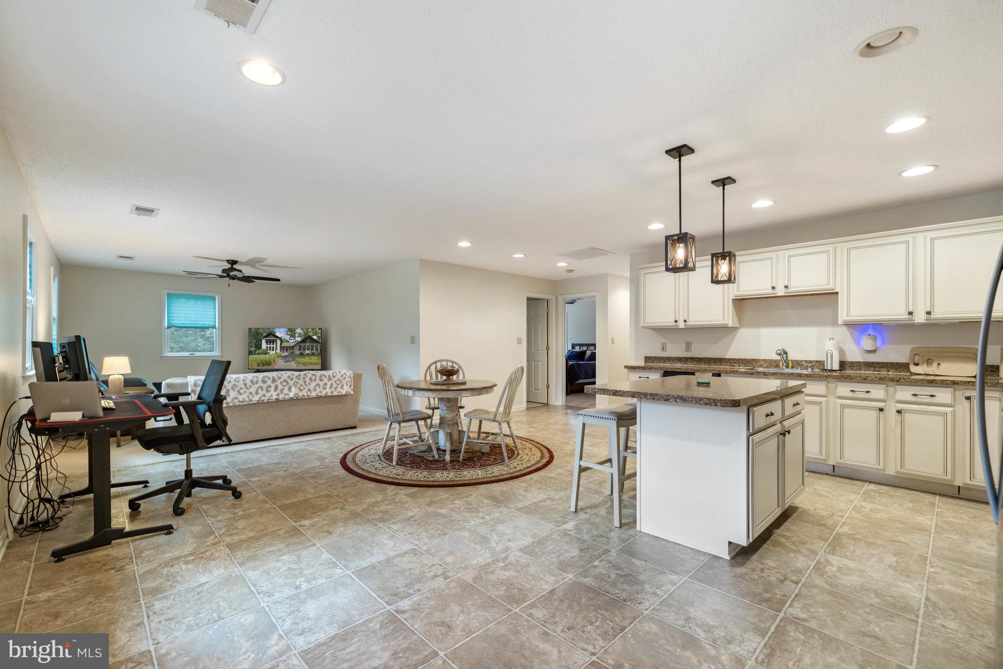 97 Tilthammer Mill Road Boyce, VA 22620 - Photo 35 of 68 a kitchen with stainless steel appliances kitchen island granite countertop a stove a sink a dining table and chairs with wooden floor