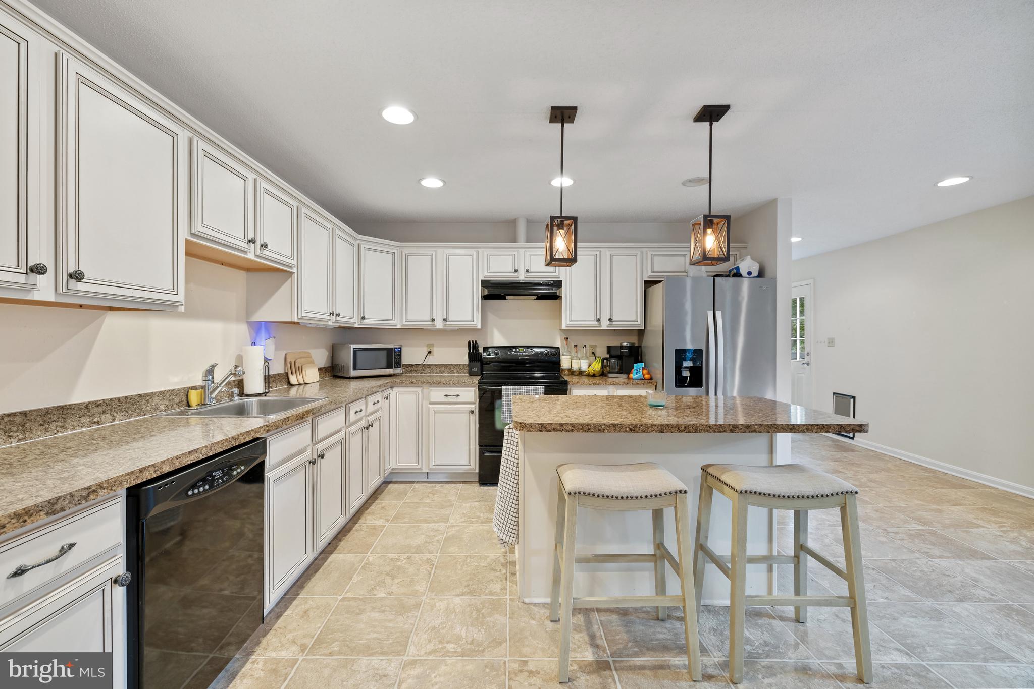 97 Tilthammer Mill Road Boyce, VA 22620 - Photo 36 of 68 a kitchen with stainless steel appliances granite countertop a sink a stove a refrigerator and cabinets