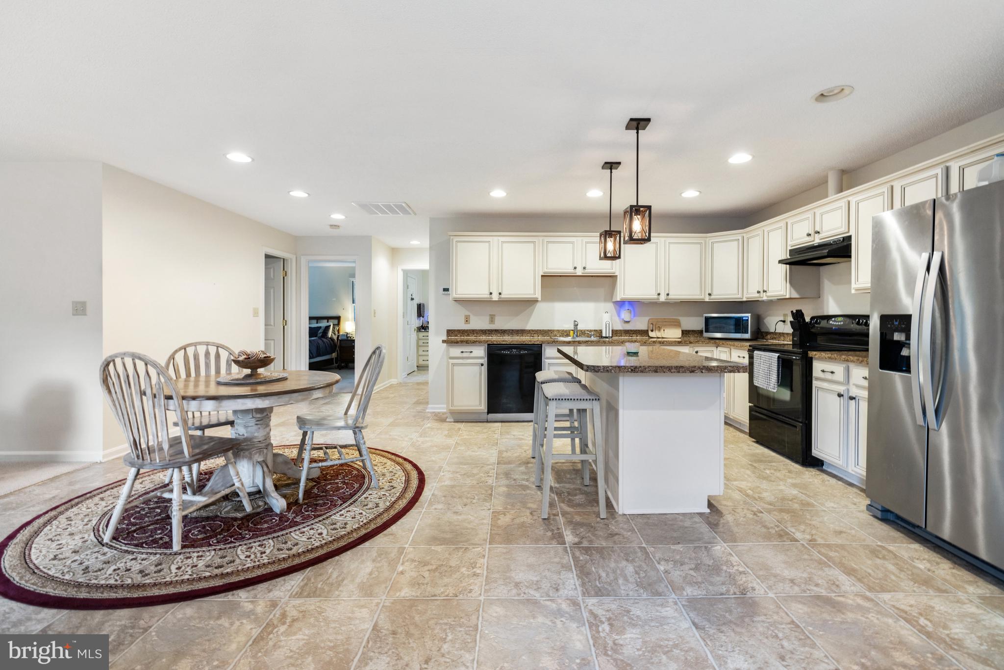 97 Tilthammer Mill Road Boyce, VA 22620 - Photo 37 of 68 a kitchen with a dining table chairs stainless steel appliances