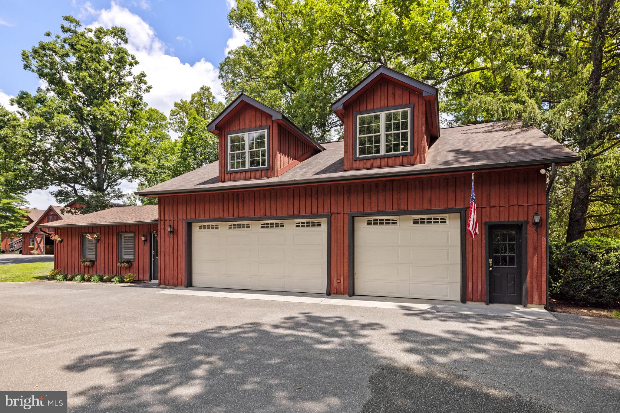 97 Tilthammer Mill Road Boyce, VA 22620 - Photo 48 of 68 a front view of a house with a yard and garage