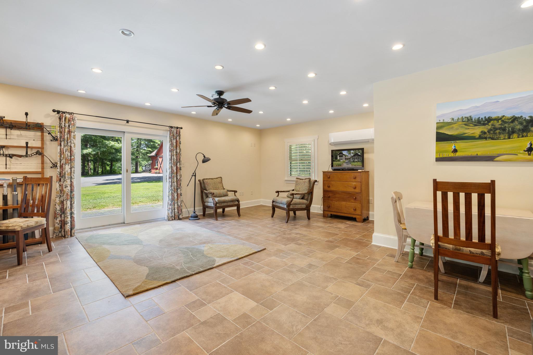 97 Tilthammer Mill Road Boyce, VA 22620 - Photo 49 of 68 a living room with furniture a flat screen tv and large windows