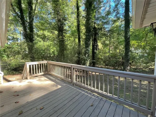 a view of balcony with wooden floor and fence