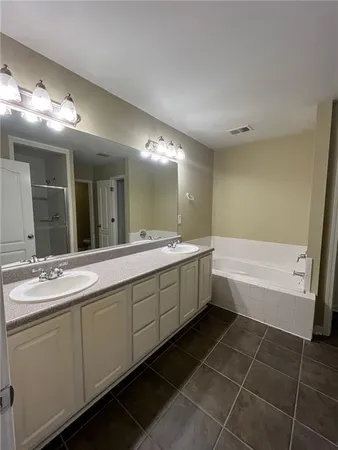 a bathroom with a bathtub sink and mirror