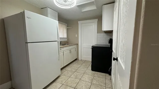 a white refrigerator freezer sitting in a kitchen
