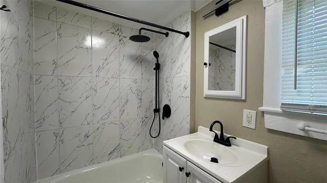 a bathroom with a sink and a shower