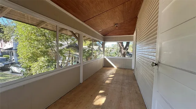 a view of a balcony with wooden floor