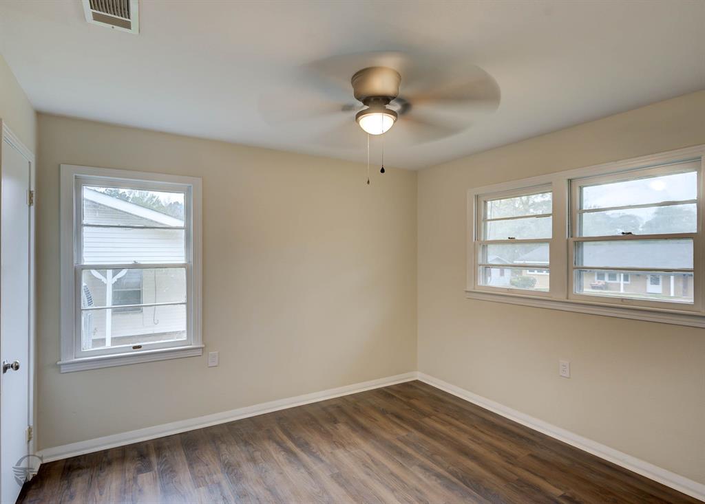 109 Milton Drive Minden, LA 71055 - Photo 20 of 24 a view of an empty room with wooden floor and a window