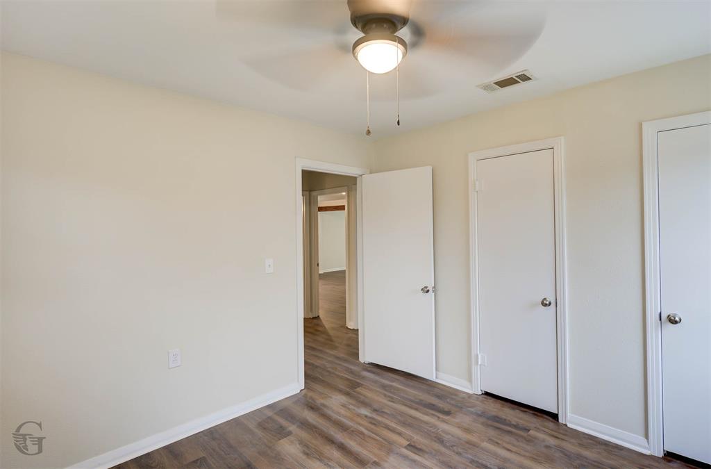 109 Milton Drive Minden, LA 71055 - Photo 21 of 24 an empty room with wooden floor and windows