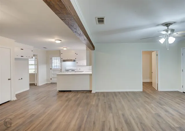 a view of kitchen with cabinets and wooden floor