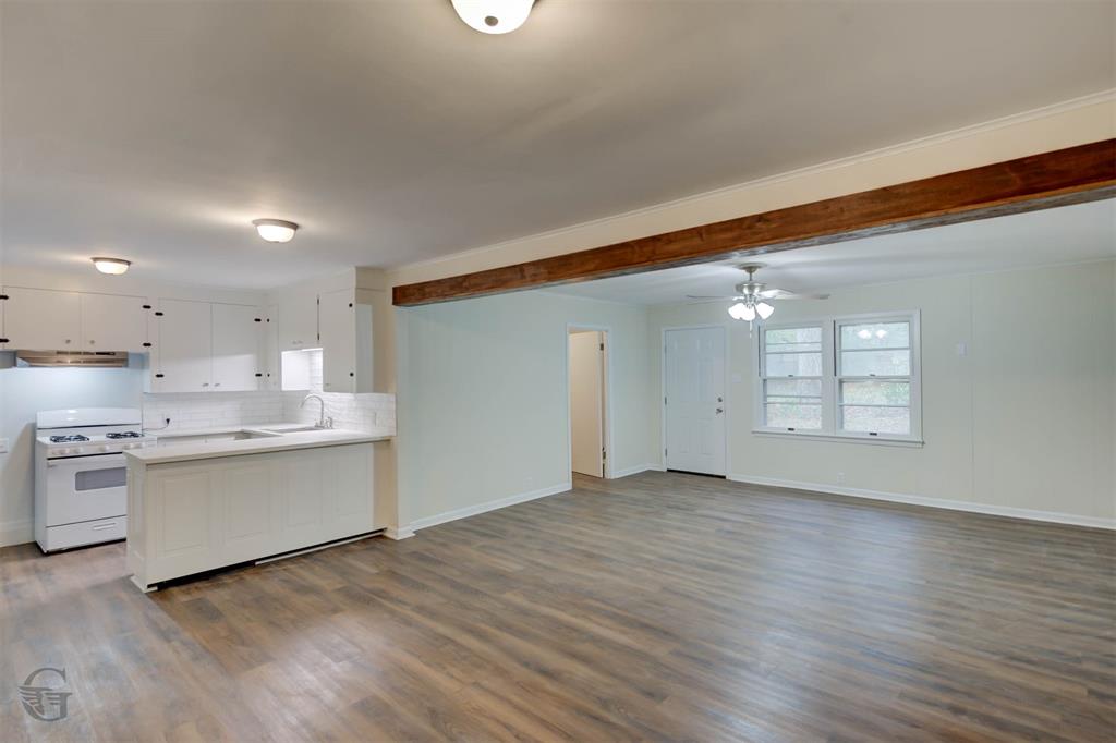 109 Milton Drive Minden, LA 71055 - Photo 7 of 24 a view of a kitchen with a sink and dishwasher a stove top oven with wooden floor