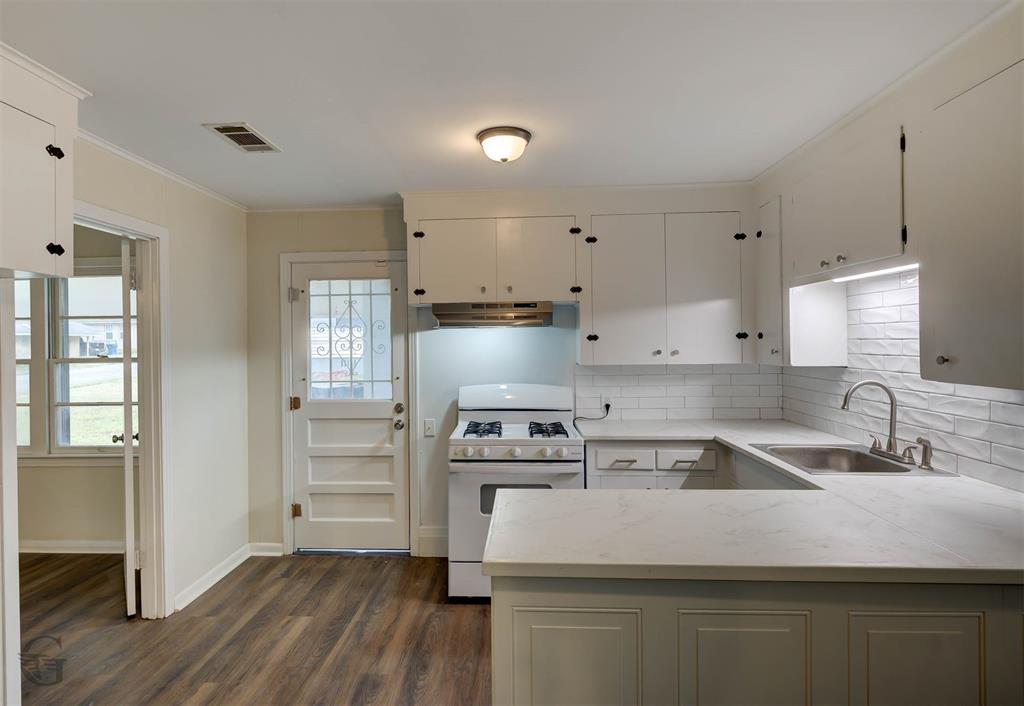 109 Milton Drive Minden, LA 71055 - Photo 8 of 24 a kitchen with kitchen island white cabinets and stainless steel appliances