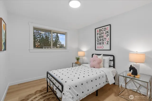 a bedroom with a bed and a lamp on table