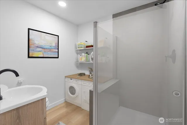 a view of a bathroom with sink dryer and washer