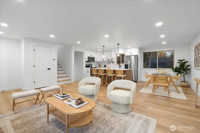 a living room with furniture and a dining table with kitchen view