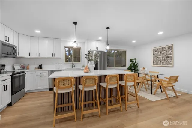 a large kitchen with a table and chairs