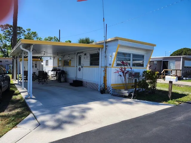 a view of a patio with table and chairs under an umbrella