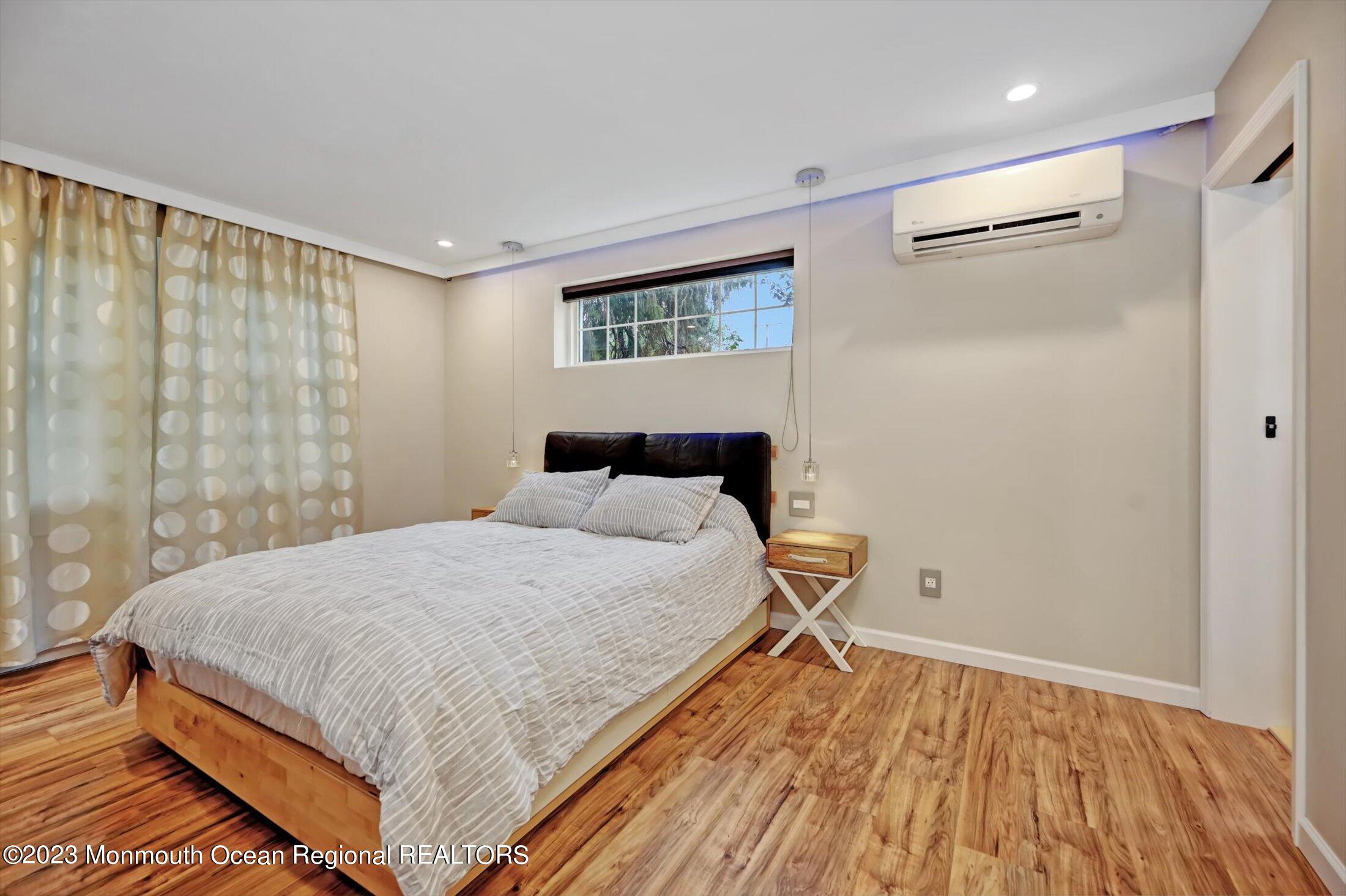 33 Conover Road Colts Neck, NJ 07722 - Photo 15 of 35 a bedroom with a bed and wooden floor