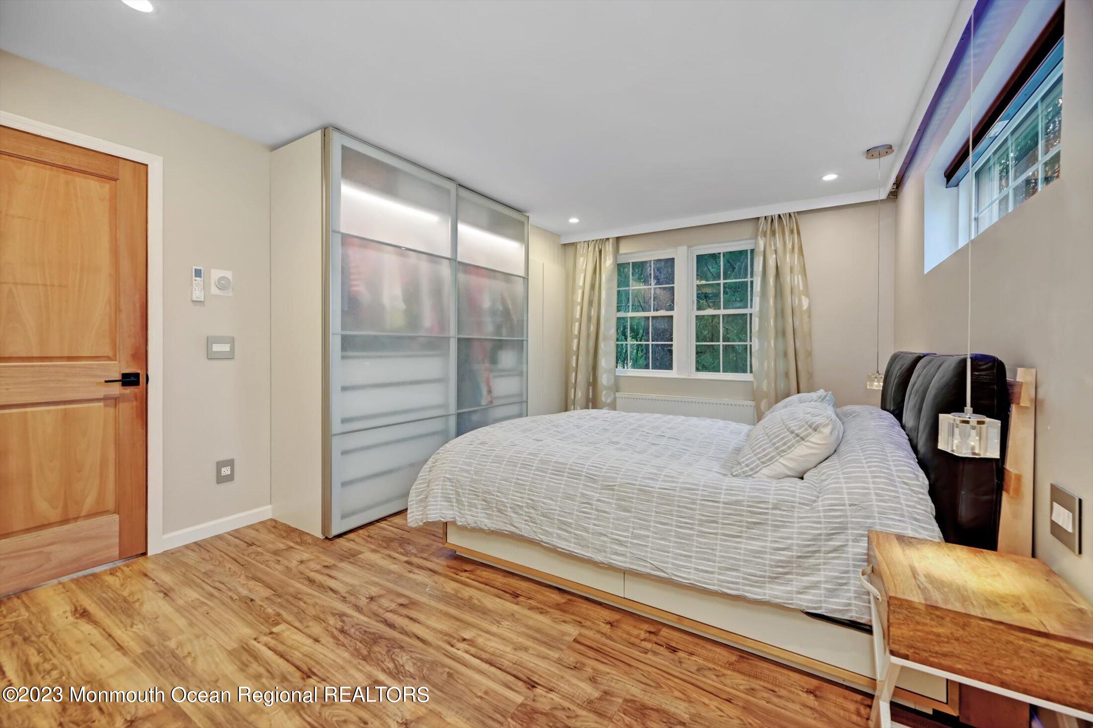 33 Conover Road Colts Neck, NJ 07722 - Photo 16 of 35 a bedroom with a bed and wooden floor