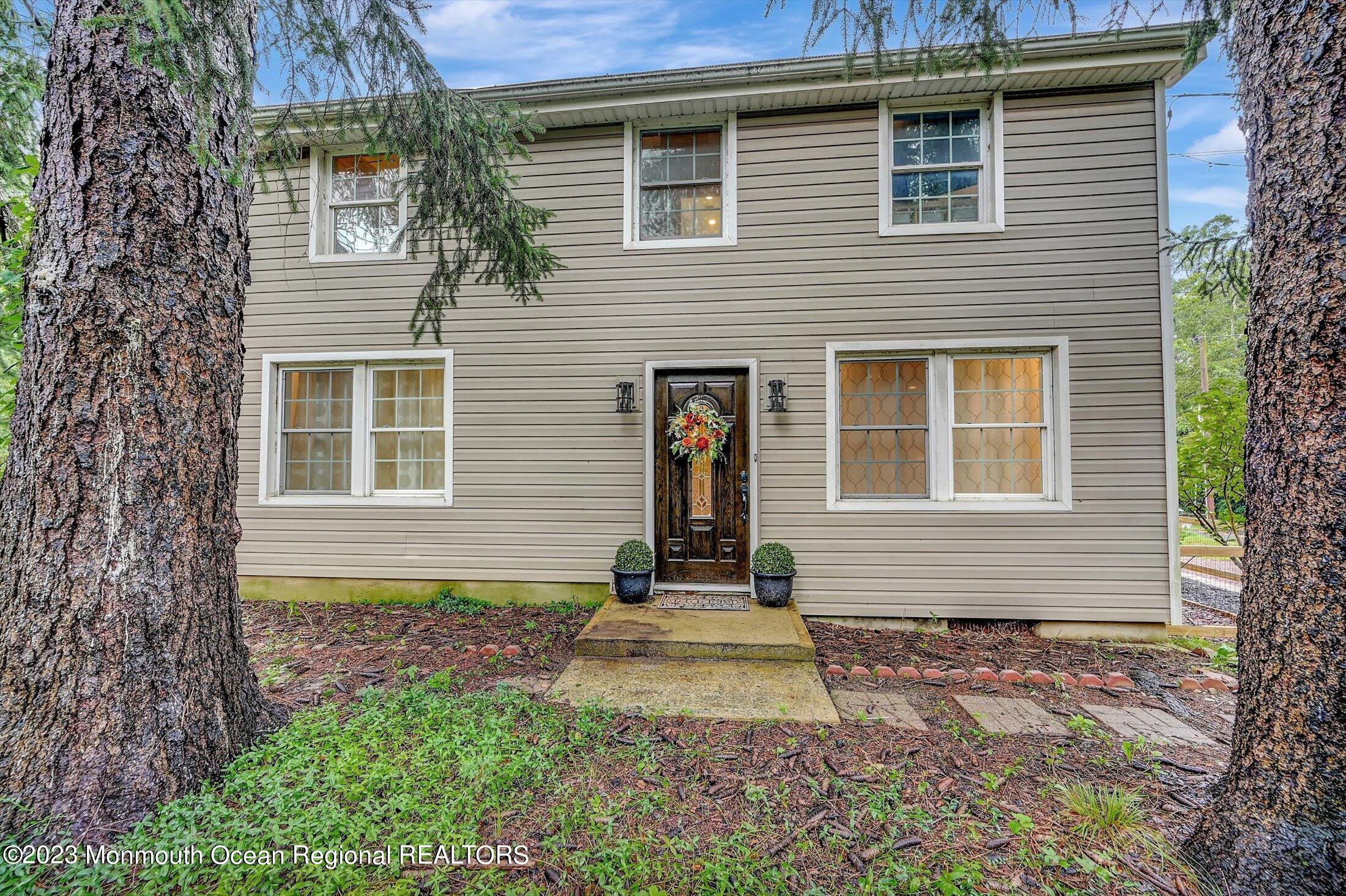 33 Conover Road Colts Neck, NJ 07722 - Photo 2 of 35 a front view of a house with garden