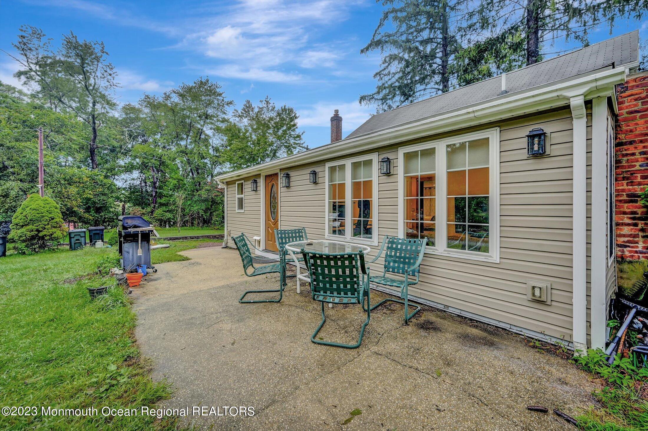 33 Conover Road Colts Neck, NJ 07722 - Photo 28 of 35 a view of a house with backyard and sitting area