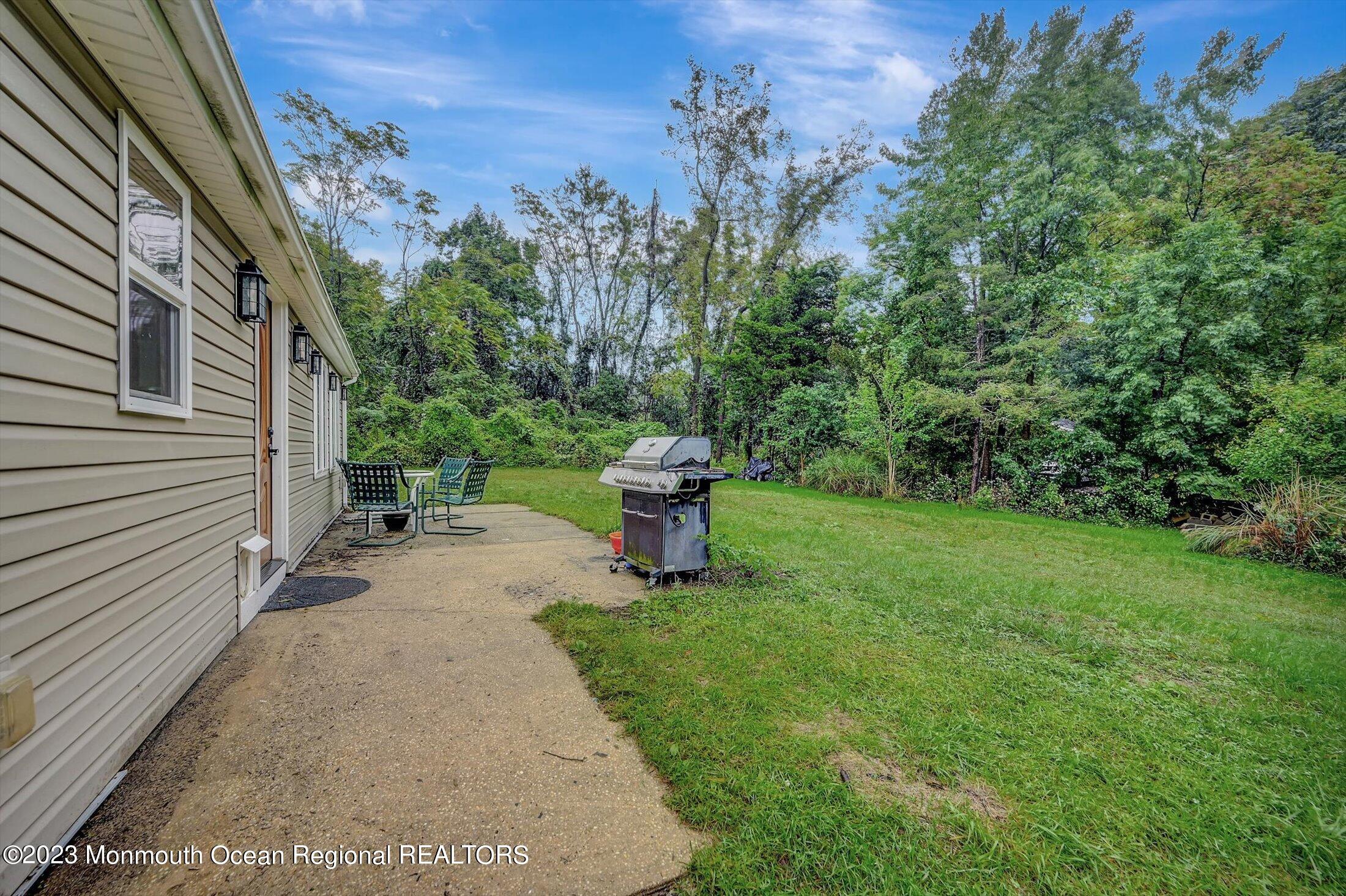 33 Conover Road Colts Neck, NJ 07722 - Photo 29 of 35 a view of a garden with plants and a bench
