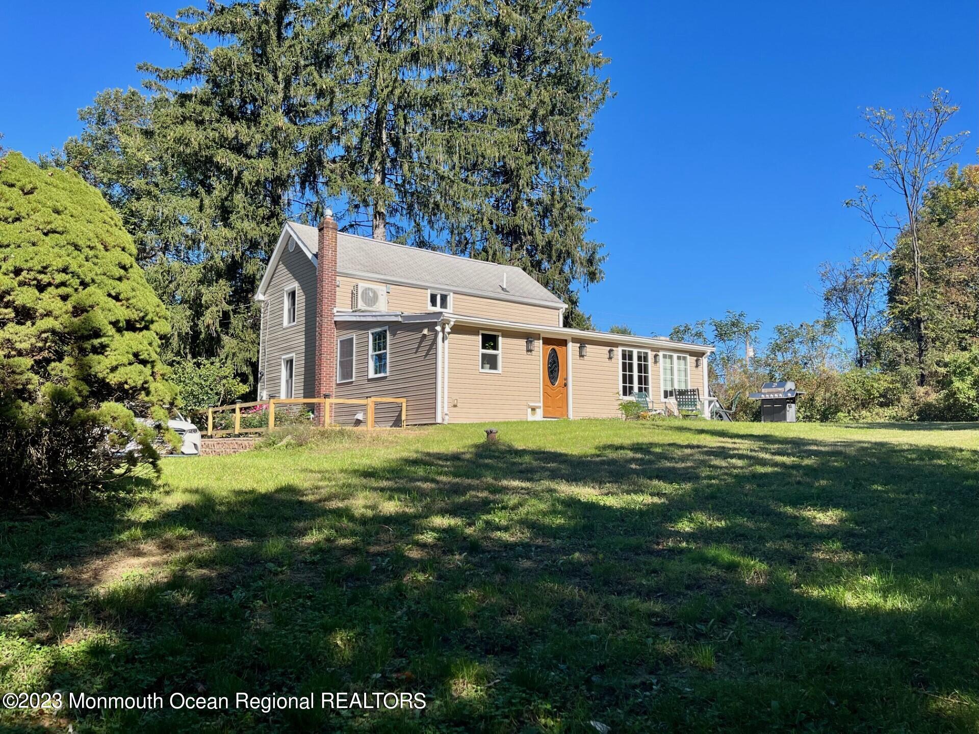 33 Conover Road Colts Neck, NJ 07722 - Photo 33 of 35 a view of a big house with a big yard plants and large trees
