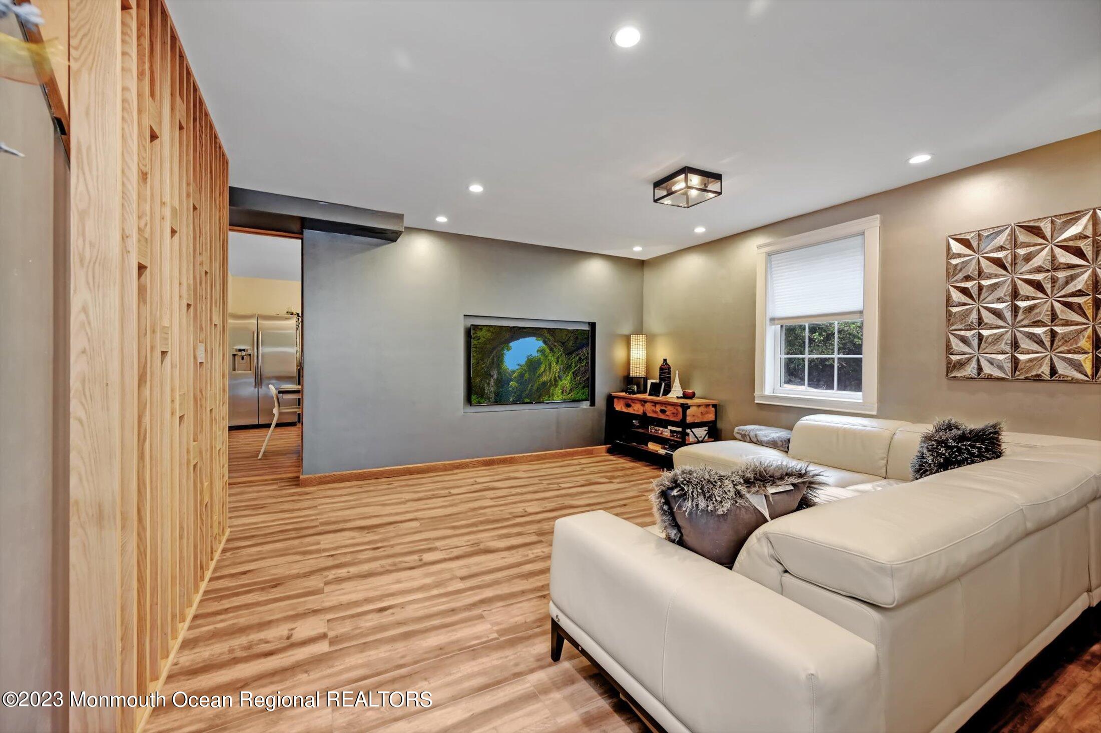 33 Conover Road Colts Neck, NJ 07722 - Photo 4 of 35 a living room with furniture and a flat screen tv