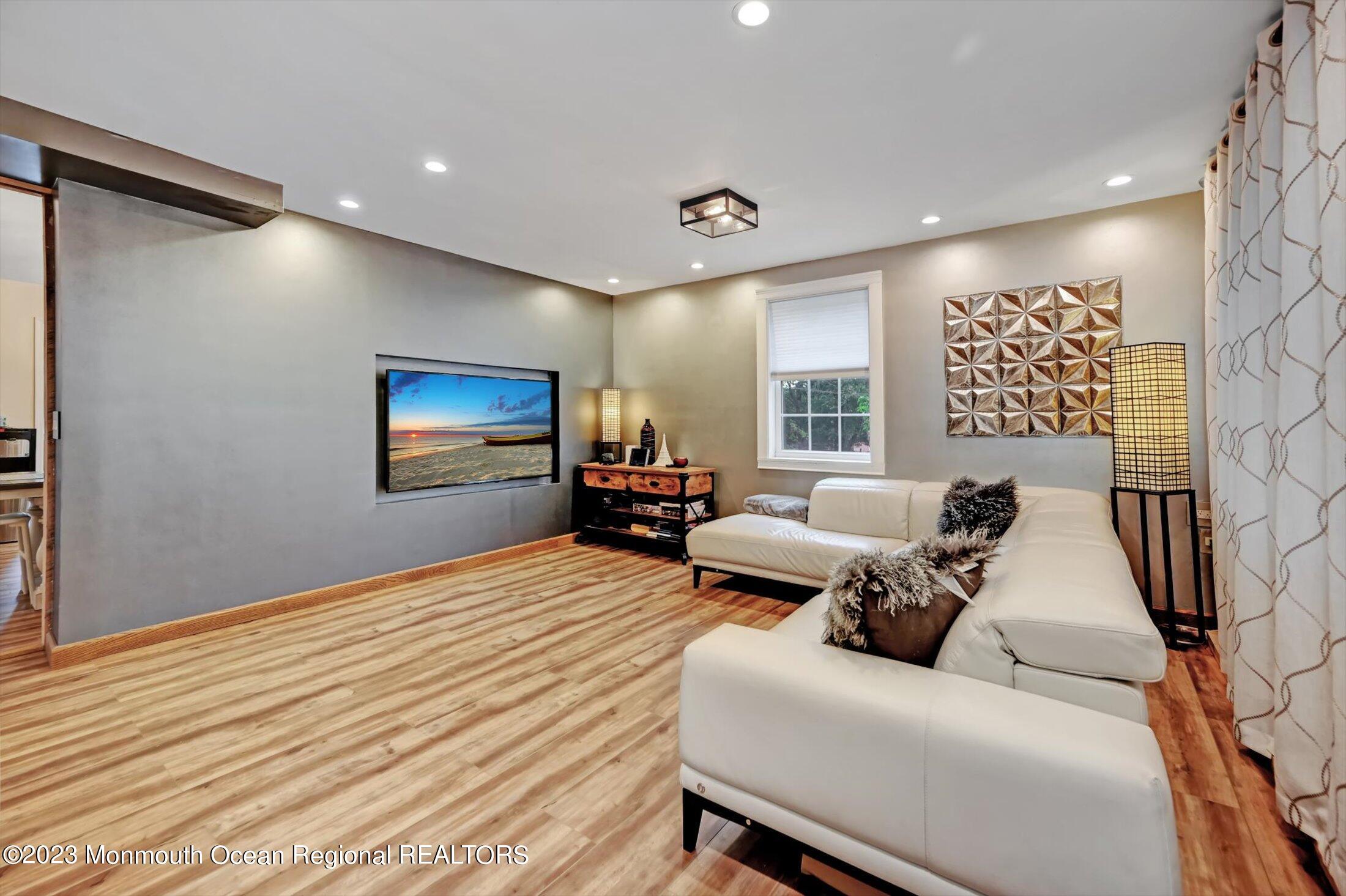 33 Conover Road Colts Neck, NJ 07722 - Photo 6 of 35 a living room with furniture and a flat screen tv