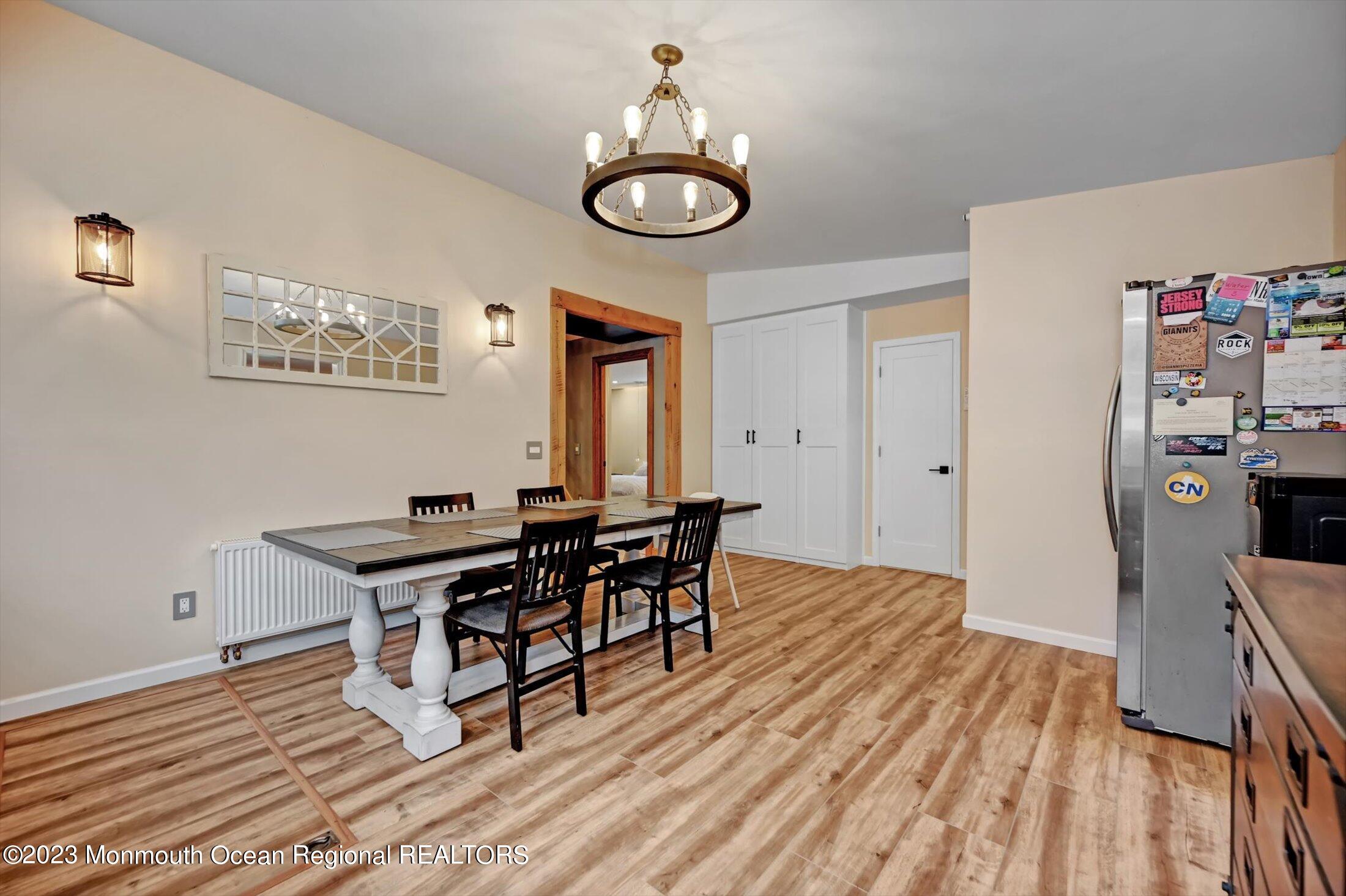 33 Conover Road Colts Neck, NJ 07722 - Photo 9 of 35 a view of a dining room with furniture and wooden floor