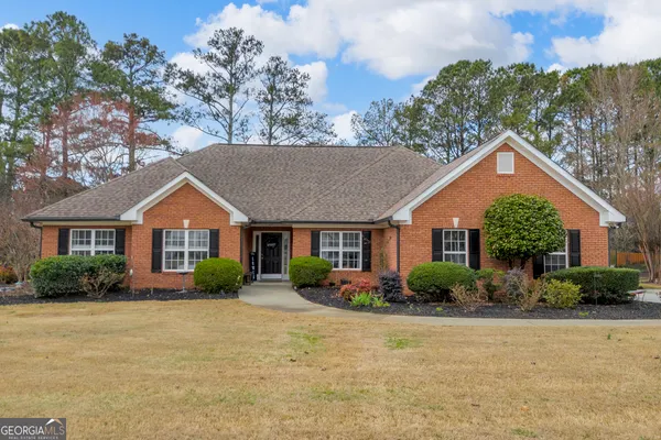 a front view of house with yard and green space