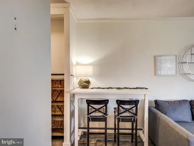 a utility room with a table and chairs