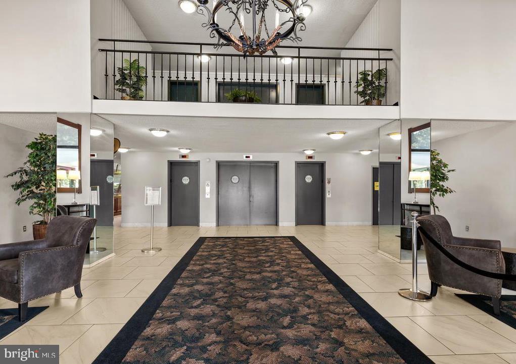 2059 Huntington Avenue, Unit 1602 Alexandria, VA 22303 - Photo 2 of 31 a lobby with furniture and a rug