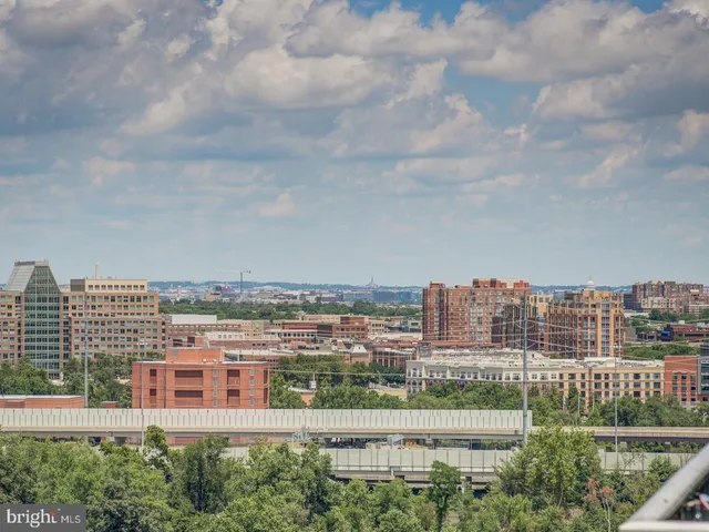 a view of a city with tall buildings and a big yard