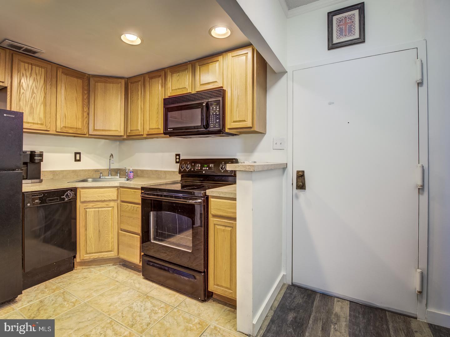 2059 Huntington Avenue, Unit 1602 Alexandria, VA 22303 - Photo 3 of 31 a kitchen with stainless steel appliances granite countertop a refrigerator a stove top oven a sink and dishwasher