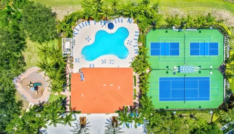 a view of a house with swimming pool and sitting area