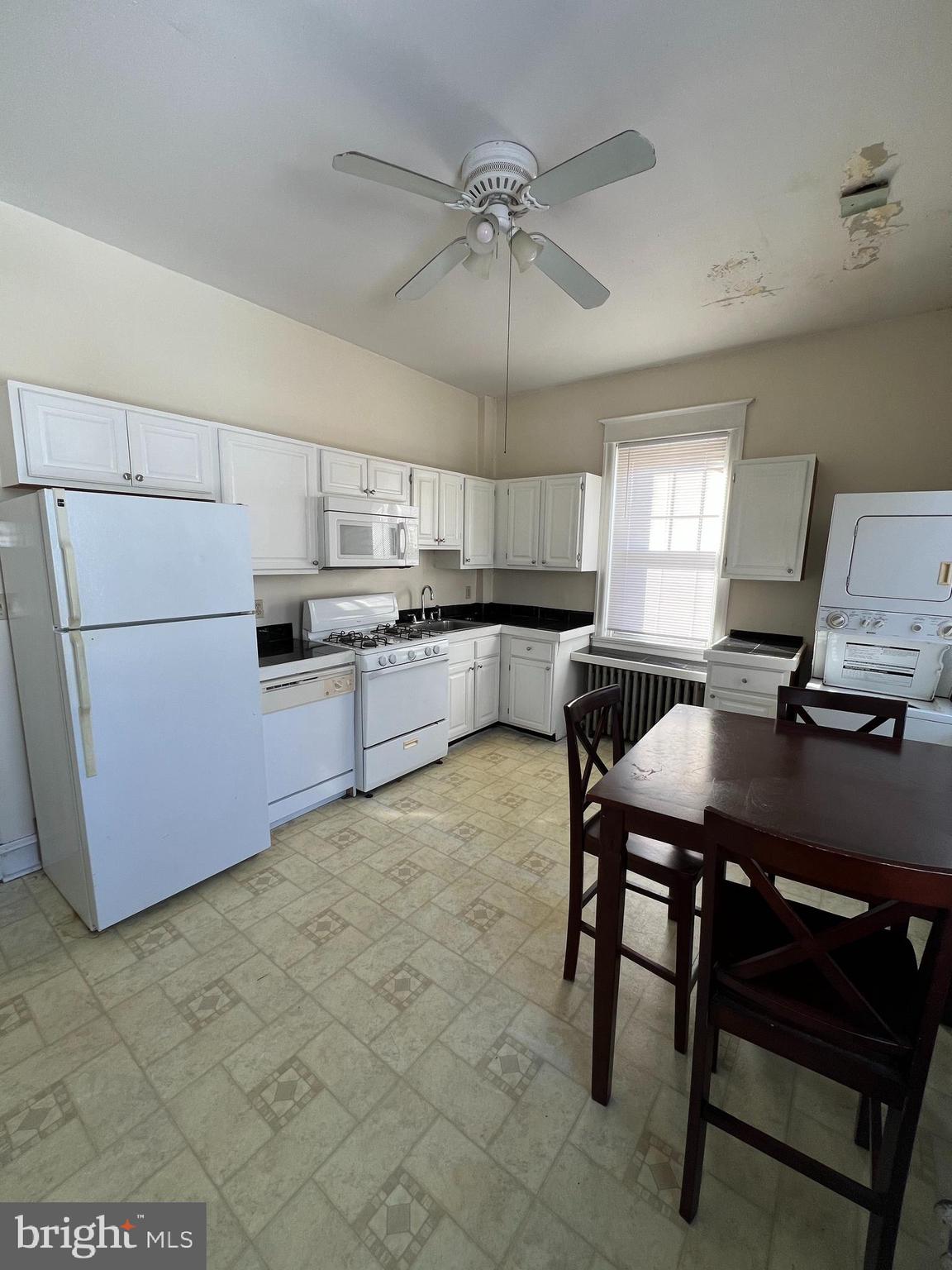 213 East Main Street Maple Shade, NJ 08052 - Photo 14 of 21 a kitchen with a table chairs refrigerator and microwave