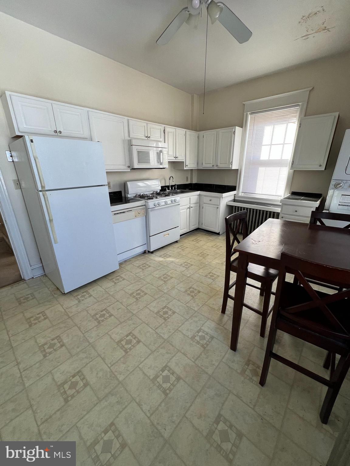 213 East Main Street Maple Shade, NJ 08052 - Photo 15 of 21 a kitchen with a refrigerator a stove a sink dishwasher with a dining table and chairs