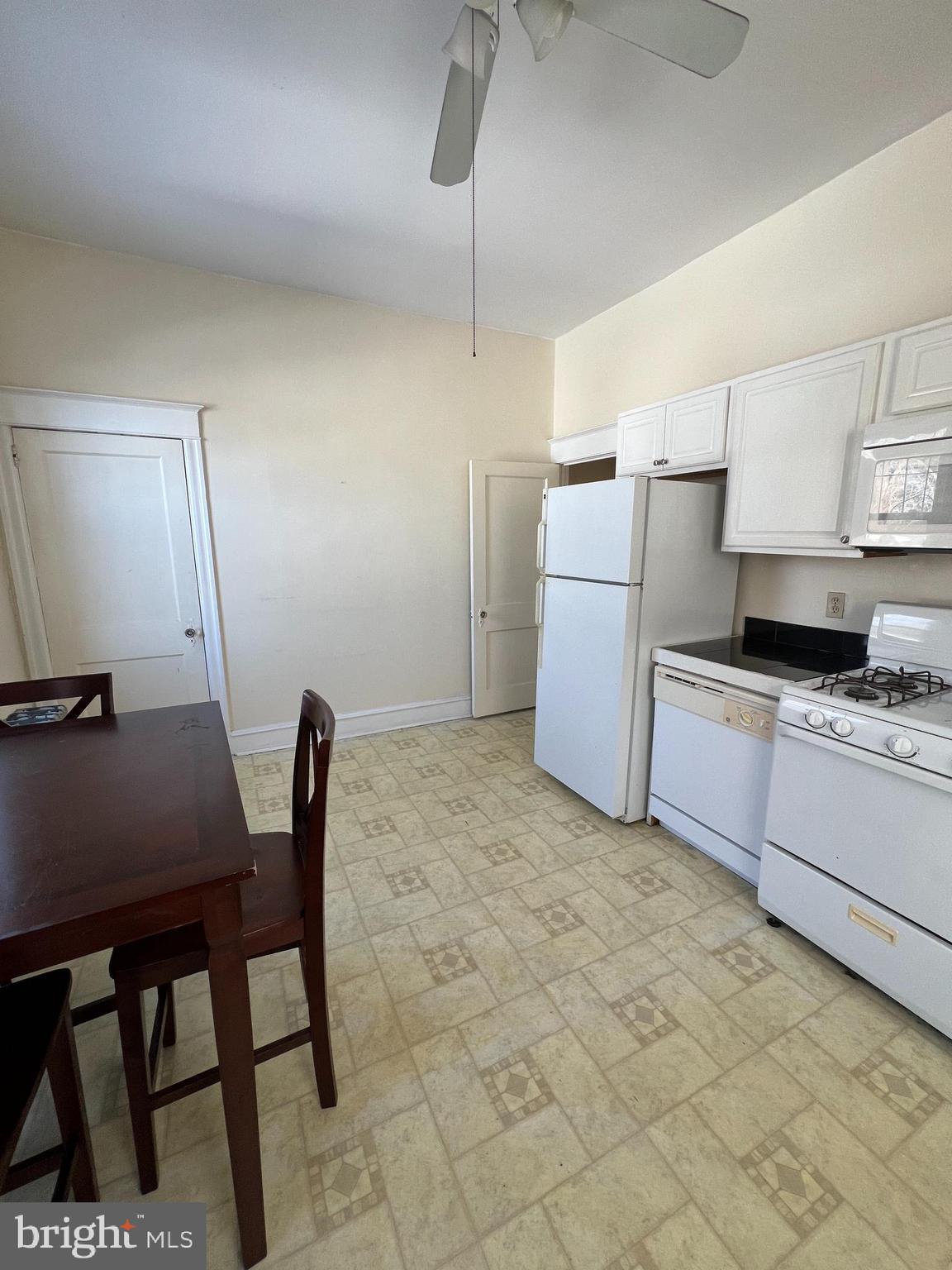 213 East Main Street Maple Shade, NJ 08052 - Photo 17 of 21 a kitchen with a table chairs refrigerator and microwave