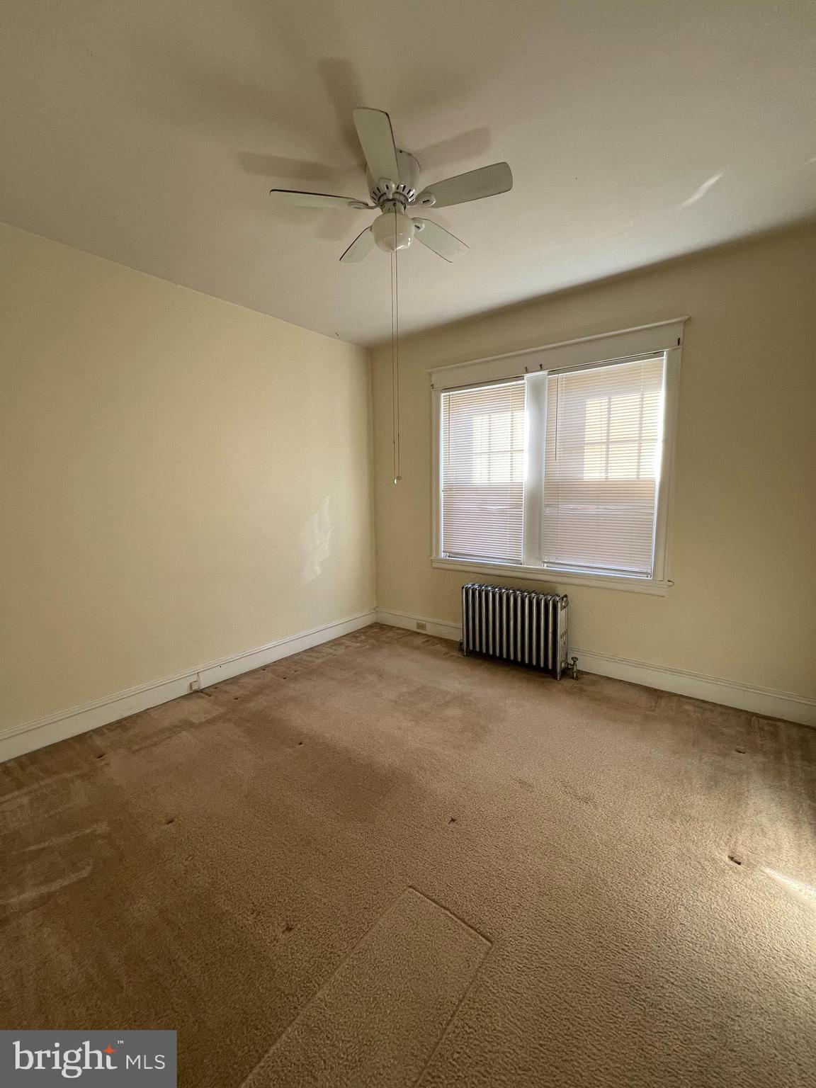 213 East Main Street Maple Shade, NJ 08052 - Photo 7 of 21 an empty room with a window and a ceiling fan