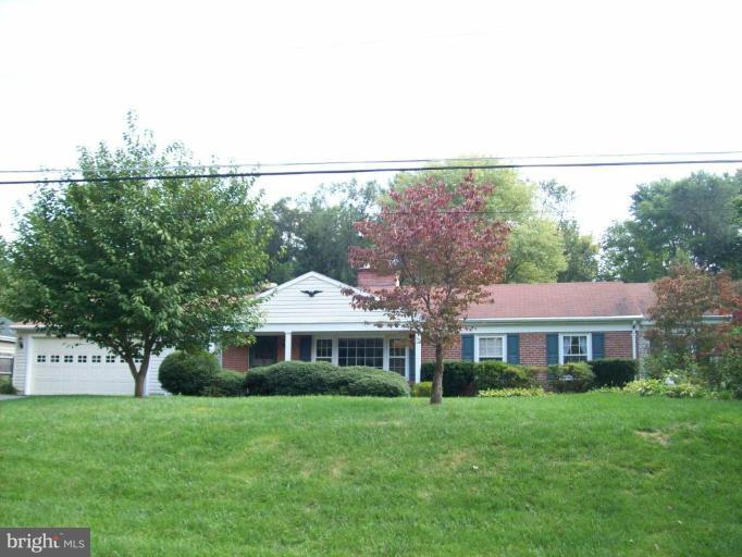 7911 Ruxway Road Towson, MD 21204 - Photo 1 of 9 a front view of a house with a garden